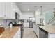 Contemporary kitchen showcasing granite countertops, stainless steel appliances, and stylish white cabinetry at 43554 Treadway Dr, Punta Gorda, FL 33982