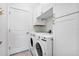 Practical laundry room with white cabinets and modern appliances at 43554 Treadway Dr, Punta Gorda, FL 33982