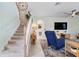 Comfortable living room with a staircase, large TV, stylish decor and plenty of space for relaxation at 43554 Treadway Dr, Punta Gorda, FL 33982