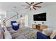 Comfortable living room with a staircase, large TV, stylish decor and plenty of space for relaxation at 43554 Treadway Dr, Punta Gorda, FL 33982