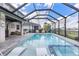 Sparkling pool with luxurious loungers and spa, perfect for outdoor relaxation and entertaining at 43554 Treadway Dr, Punta Gorda, FL 33982