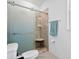 Modern shower featuring glass doors, tile surround, a built-in seat, and a convenient towel rack at 43554 Treadway Dr, Punta Gorda, FL 33982