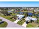 Aerial view of a well maintained neighborhood, showcasing lush landscaping and a prime waterfront location at 483 Corrientes Cir, Punta Gorda, FL 33983