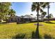 Expansive backyard with a screened-in pool and mature palm trees, providing a private and tropical oasis at 483 Corrientes Cir, Punta Gorda, FL 33983