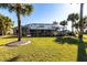 Lush backyard featuring a screened-in pool, vibrant greenery, and mature landscaping for ultimate privacy at 483 Corrientes Cir, Punta Gorda, FL 33983