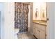 Bathroom features a toilet, vanity, mirror, shower with curtain, and tile flooring at 483 Corrientes Cir, Punta Gorda, FL 33983