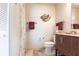 Bathroom features a toilet, vanity, mirror, shower with curtain, and tile flooring at 483 Corrientes Cir, Punta Gorda, FL 33983