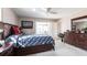 Bright bedroom with a ceiling fan, a dresser with a mirror, and a view of the patio at 483 Corrientes Cir, Punta Gorda, FL 33983
