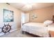 Neutral bedroom with nautical decor, simple bed frame, and a ceiling fan at 483 Corrientes Cir, Punta Gorda, FL 33983