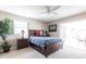 Bright bedroom with a ceiling fan, a window, a door to the patio, and carpet flooring at 483 Corrientes Cir, Punta Gorda, FL 33983