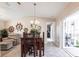 Bright dining room with vaulted ceilings leading to a sliding glass door at 483 Corrientes Cir, Punta Gorda, FL 33983