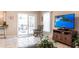 Cozy living room showing sliding doors, a TV, and tile flooring at 483 Corrientes Cir, Punta Gorda, FL 33983