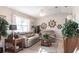 Living room area featuring comfortable couches, tile flooring, and nautically themed decorations at 483 Corrientes Cir, Punta Gorda, FL 33983