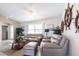 Cozy living room featuring nautical décor, comfortable seating, and an abundance of natural light at 483 Corrientes Cir, Punta Gorda, FL 33983
