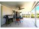 Covered patio features a grill, ceiling fan, seating area and access to the interior at 483 Corrientes Cir, Punta Gorda, FL 33983