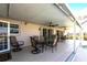 Covered patio features several seating areas, ceiling fans, and a screened enclosure at 483 Corrientes Cir, Punta Gorda, FL 33983