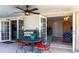Covered patio features a grill, ceiling fan, seating area and access to the interior at 483 Corrientes Cir, Punta Gorda, FL 33983