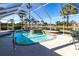 Sparkling pool with attached spa inside screened enclosure, with a relaxing view of the adjacent waterway at 483 Corrientes Cir, Punta Gorda, FL 33983