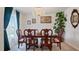 Formal dining room with elegant chandelier, wooden table and chairs at 4980 Dakota Ter, North Port, FL 34286