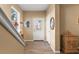 Well lit foyer featuring wood look tile flooring, half round window and white front door at 1071 Jonah Dr, North Port, FL 34289