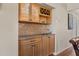 Stylish bar area featuring a wine rack, glass storage, granite counters and tile backsplash at 1340 San Cristobal Ave # 304, Punta Gorda, FL 33983