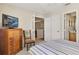 Cozy bedroom with a television, dresser and comfortable striped bedding at 1340 San Cristobal Ave # 304, Punta Gorda, FL 33983