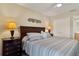 Comfortable bedroom featuring a wooden headboard and side tables with lamps at 1340 San Cristobal Ave # 304, Punta Gorda, FL 33983