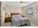 Serene bedroom with a ceiling fan, neutral colors, and a window providing natural light at 1340 San Cristobal Ave # 304, Punta Gorda, FL 33983