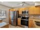 Bright kitchen featuring stainless steel appliances, granite counters, and light wood cabinetry at 1340 San Cristobal Ave # 304, Punta Gorda, FL 33983