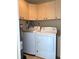 Laundry room with modern washer and dryer and upper cabinets at 1340 San Cristobal Ave # 304, Punta Gorda, FL 33983