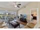 Comfortable living room with wood floors, vaulted ceiling, and view of the lanai and golf course beyond at 1340 San Cristobal Ave # 304, Punta Gorda, FL 33983