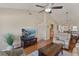 Cozy living room with wood floors, vaulted ceiling, and a view of the adjacent dining area and bar at 1340 San Cristobal Ave # 304, Punta Gorda, FL 33983