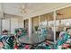 Enclosed lanai features a ceiling fan, comfortable seating, and sliding glass doors at 1340 San Cristobal Ave # 304, Punta Gorda, FL 33983