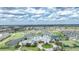 Aerial view of the community showing the clubhouse, pool, tennis courts, and surrounding homes at 1673 Palace Ct, Port Charlotte, FL 33980