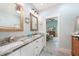 Stylish bathroom boasting dual vanities, modern fixtures, and a doorway leading to the main bedroom at 1673 Palace Ct, Port Charlotte, FL 33980