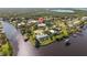 Aerial view of waterfront single-Gathering home on a canal, surrounded by lush greenery at 2012 River Basin Ter, Punta Gorda, FL 33982