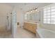 Well-lit bathroom featuring tile floors, a shower, a bathtub, and a double vanity at 2012 River Basin Ter, Punta Gorda, FL 33982