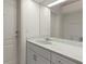 Neutral toned bathroom with white vanity and a large mirror at 2012 River Basin Ter, Punta Gorda, FL 33982