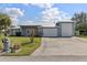Charming single-Gathering home featuring a metal roof, two-car garage, and well-manicured lawn at 2012 River Basin Ter, Punta Gorda, FL 33982