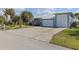 The metal roof and large driveway accent this home's curb appeal, along with its serene landscaping and modern design at 2012 River Basin Ter, Punta Gorda, FL 33982