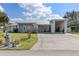 Charming home showcases a metal roof, an oversized driveway, and a welcoming exterior design, enhancing curb appeal at 2012 River Basin Ter, Punta Gorda, FL 33982
