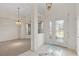 Bright foyer with tile flooring, decorative door, and view into the living area at 2012 River Basin Ter, Punta Gorda, FL 33982