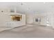 Expansive living room with open kitchen, neutral carpet, and natural light at 2012 River Basin Ter, Punta Gorda, FL 33982