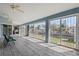 Enclosed sunroom with ceiling fans, tiled floors, and sliding windows overlooking the canal at 2012 River Basin Ter, Punta Gorda, FL 33982