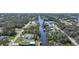 Aerial view of property on canal, with pool, boat dock and lush landscaping at 3487 Cabaret St, Port Charlotte, FL 33948