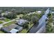 An aerial view of a waterfront home, showcasing its screened-in pool and beautiful canal access at 3487 Cabaret St, Port Charlotte, FL 33948