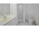 Bright bathroom featuring a walk-in shower, single vanity sink, and toilet at 3487 Cabaret St, Port Charlotte, FL 33948