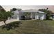 This house features a well-manicured front lawn and a classic white exterior at 3487 Cabaret St, Port Charlotte, FL 33948