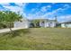 Charming one-story home with a well-manicured lawn and lush landscaping at 3487 Cabaret St, Port Charlotte, FL 33948
