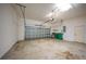 Two car garage featuring an automatic garage door and green garbage cans at 3487 Cabaret St, Port Charlotte, FL 33948